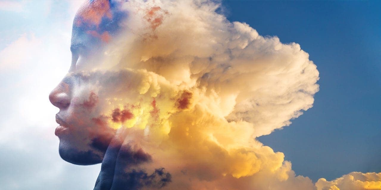 side view photo of a woman then half of it is a cloud or smoke